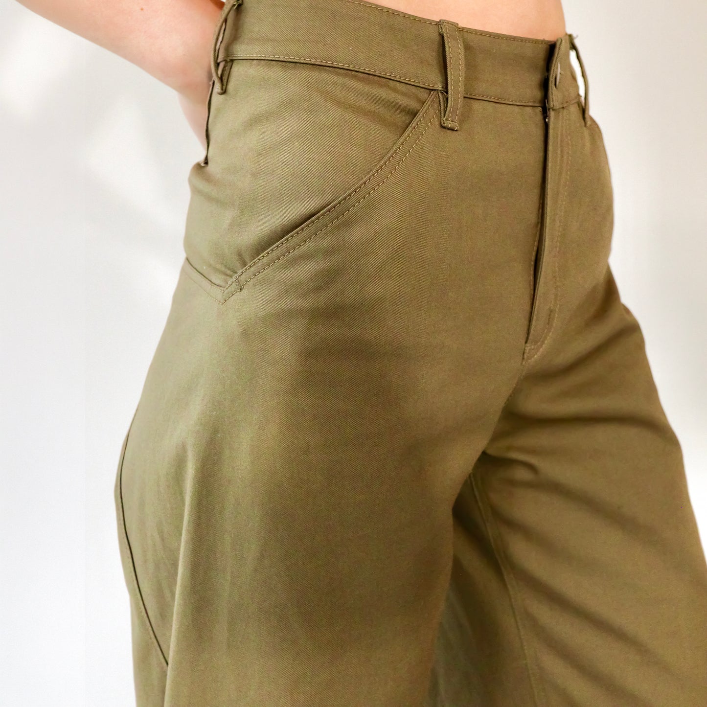 close up of person wearing Khaki wide leg cotton trousers, extra long for tall people on a white background