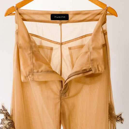 sheer trousers on a hanger with machine embroidered flower design elements