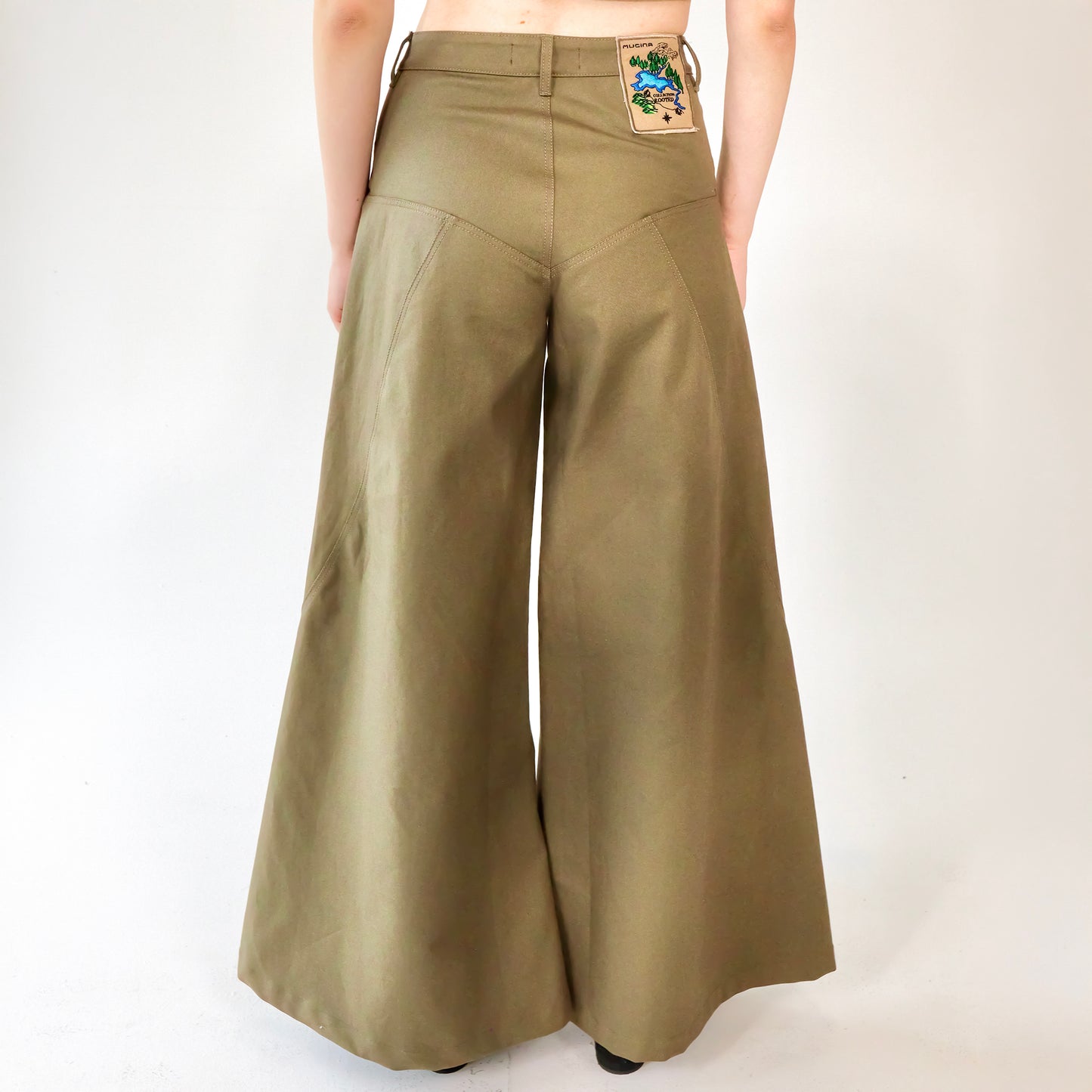 person wearing Khaki wide leg cotton trousers, extra long for tall people on a white background