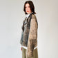 Person wearing a patterned black and brown soft lambskin leather aviator style jacket over a white shirt with black embroidered ant designs on a light gray background. made by mucina studio in latvia