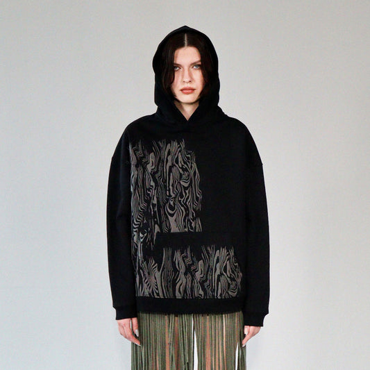 person wearing a limited quantity black french terry heavyweight hoodie with screen print graphic on front. hoodie made in riga, latvia