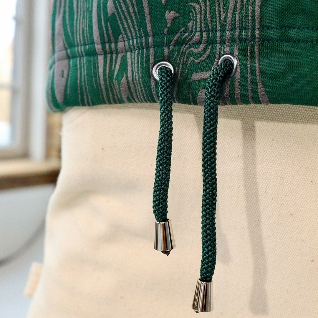 close up of cropped green hoodie with drawstring waist