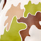 Close-up of a camouflage-patterned fabric with green, brown, and beige colors.