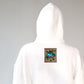 close up of embroidered nature motif label  on the back of a white hoodie